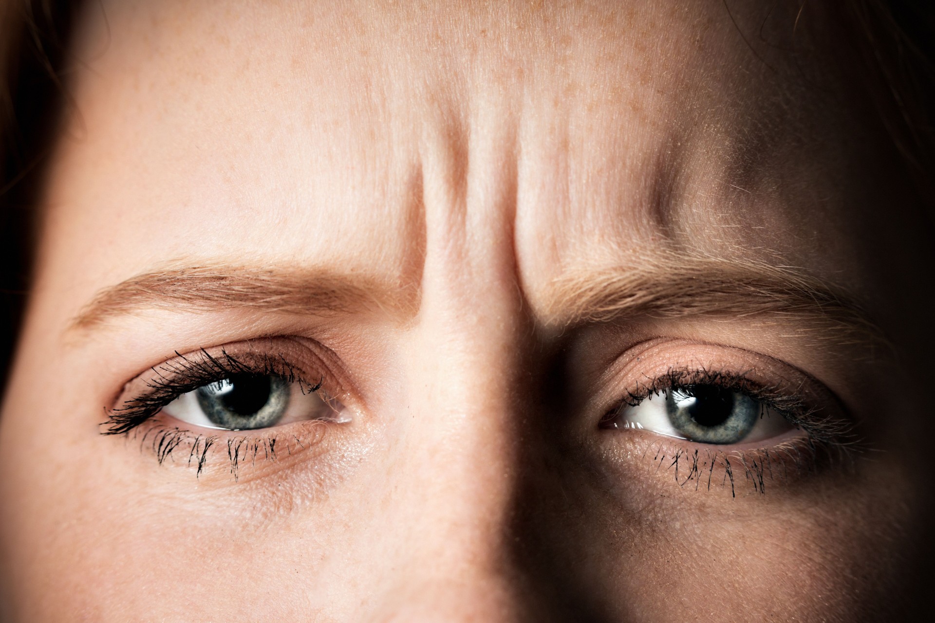 Frowning face of young woman in close-up